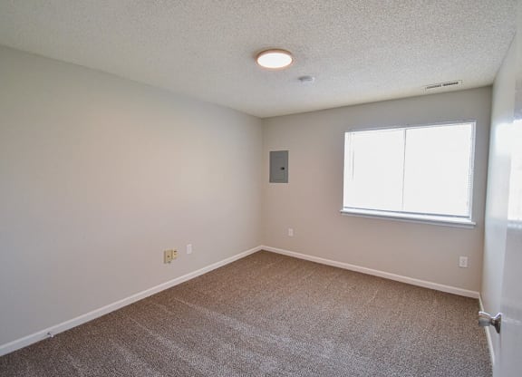 Carpeted bedroom with window