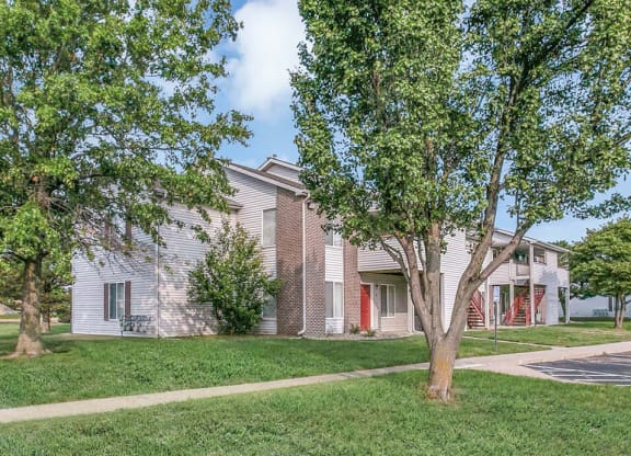 Exterior of Northridge Crossing apartments with trees and green area