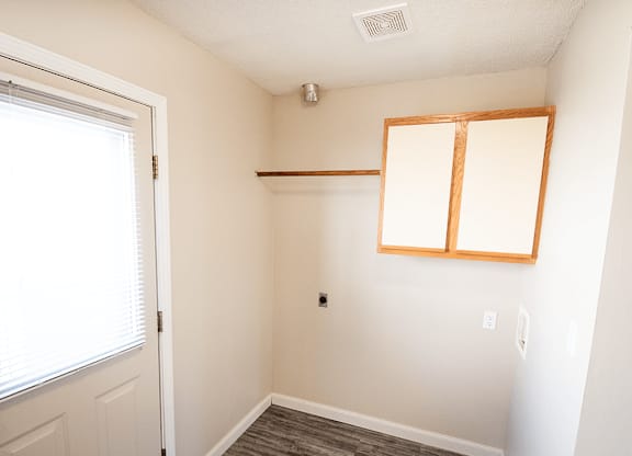 A room with a window and a door.