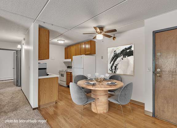 A photo of a room with a table and chairs in the middle.