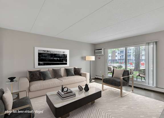 A living room with a couch, chair, and coffee table.