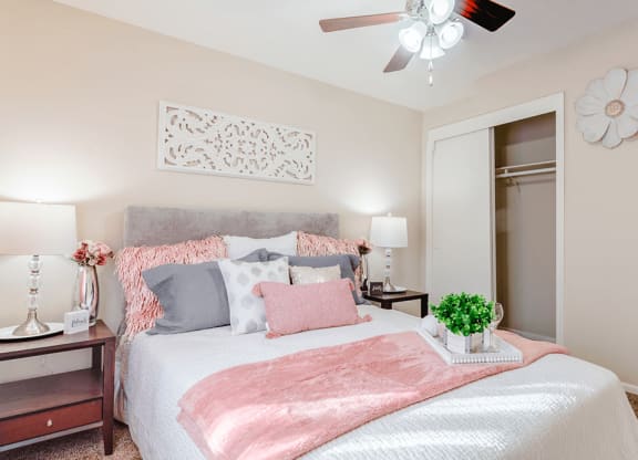 a bedroom with a large bed and a ceiling fan