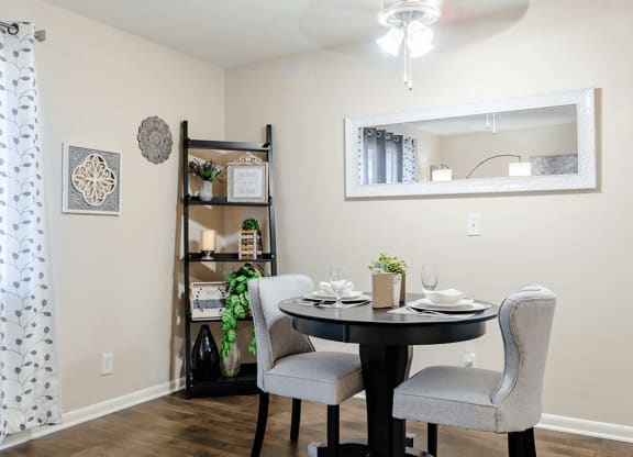 a dining room with a table and chairs
