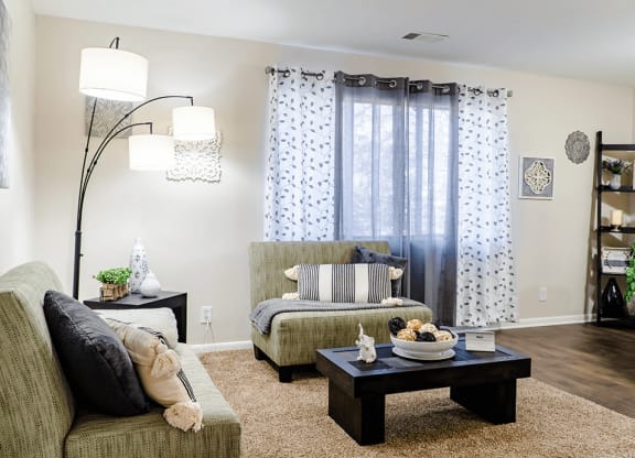 a living room with a couch and a chair and a coffee table