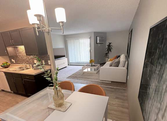 a kitchen and living room with a white table and chairs