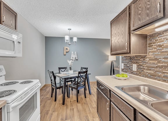 a kitchen and dining room with a table and chairs