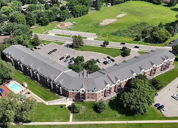 A large building with a pool in front of it.