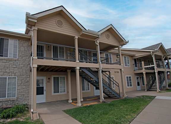 Apartment complex with a mix of stone and siding exteriors.