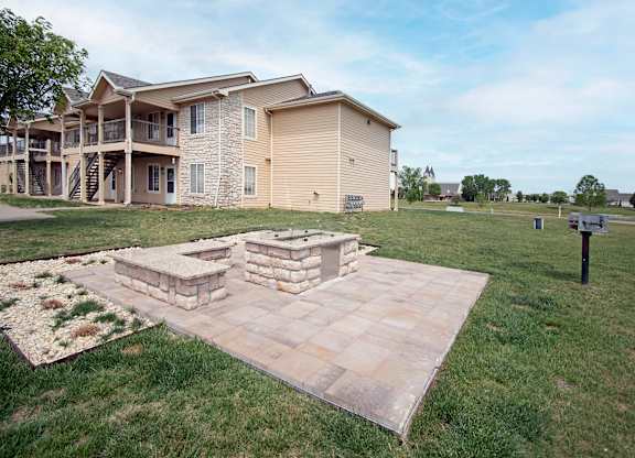 A large building with a stone fireplace in front of it.