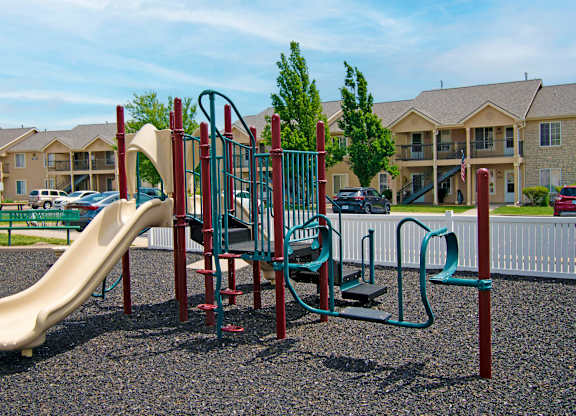 A playground with a slide, swings, and a climbing frame.