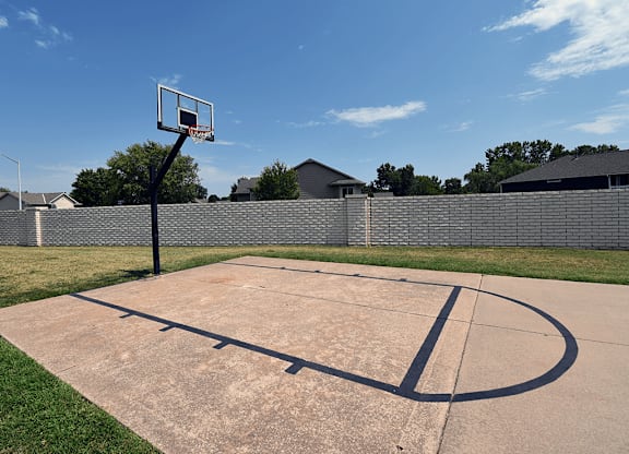 A basketball court with a hoop and a backboard.