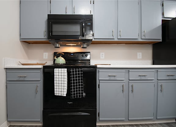 A black oven with a pot on top of it.