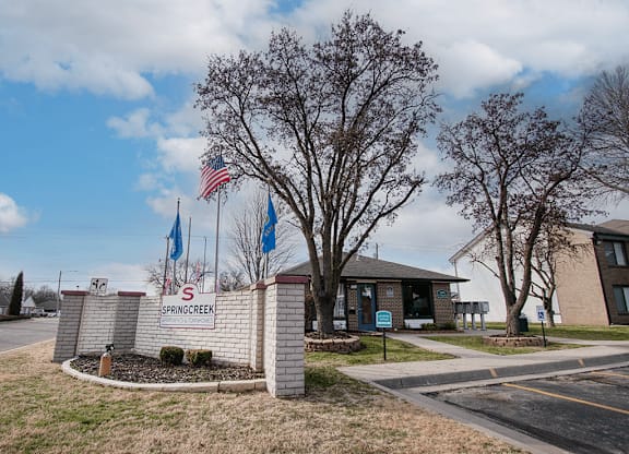 Spring creek sign in front of building.