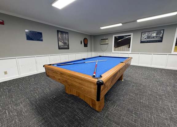 A pool table in a room with a blue cloth.