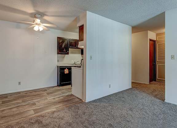 A room with a ceiling fan and a wood burning stove.