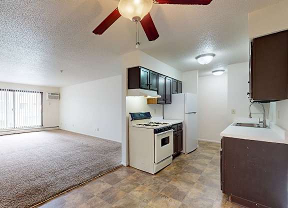 A kitchen with a white oven and a brown counter.