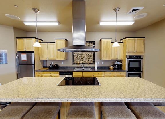 a kitchen with a large island and a stove top oven