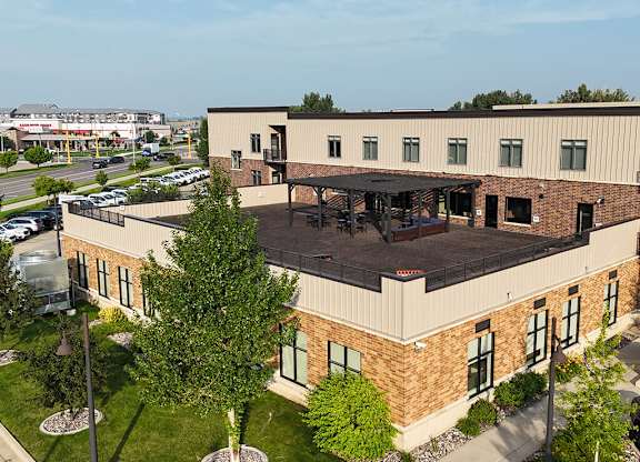 A large building with a parking lot in front of it.