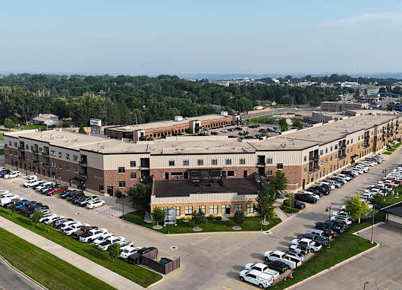 A large building with a parking lot in front of it.