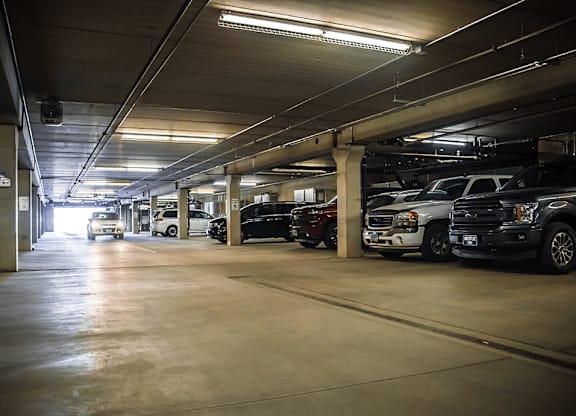 a parking garage filled with cars at apartment complex