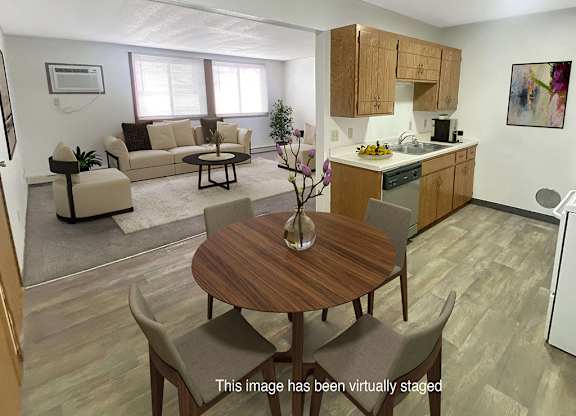 A kitchen with a table and chairs in the middle of the room.