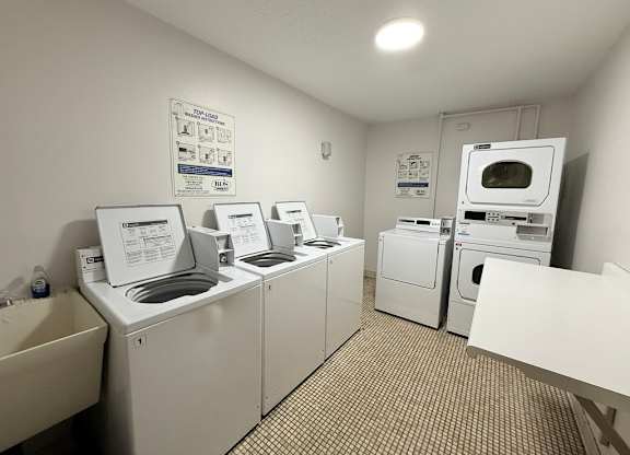 A laundry room with washers and dryers.