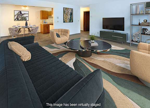 A living room with a black sofa and a coffee table.