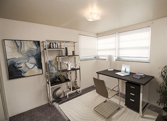 a small office with a desk and chair