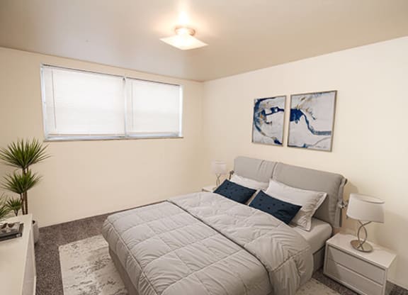 a bedroom with a bed and two night stands
