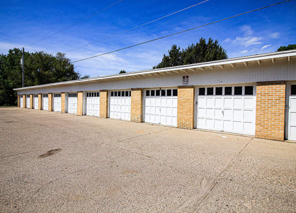 a row of garages with a blue sky in the background