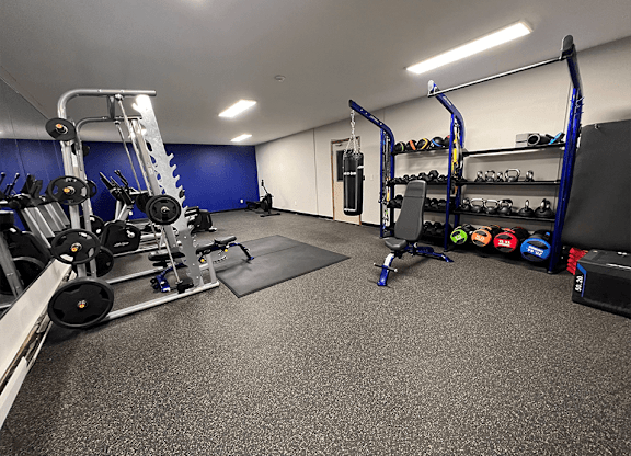 a fully equipped gym with weights and other exercise equipment