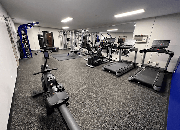 a spacious fitness center with treadmills and other exercise equipment