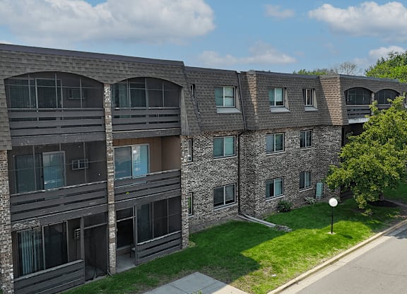 Apartment building with a green lawn in front.