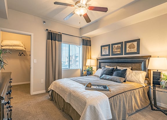 main apartment bedroom with window and walk-in closet