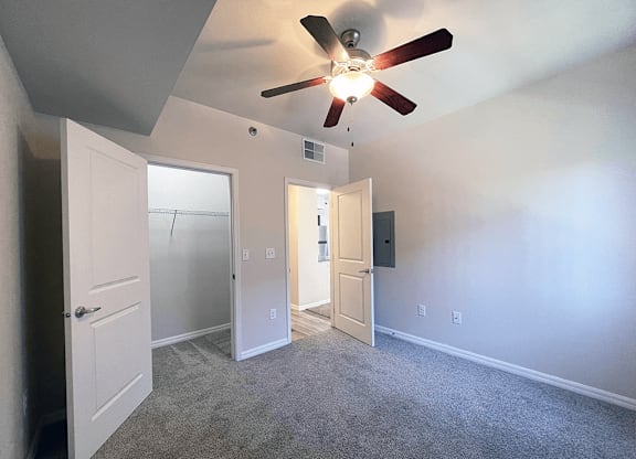 Apartment bedroom with a ceiling fan