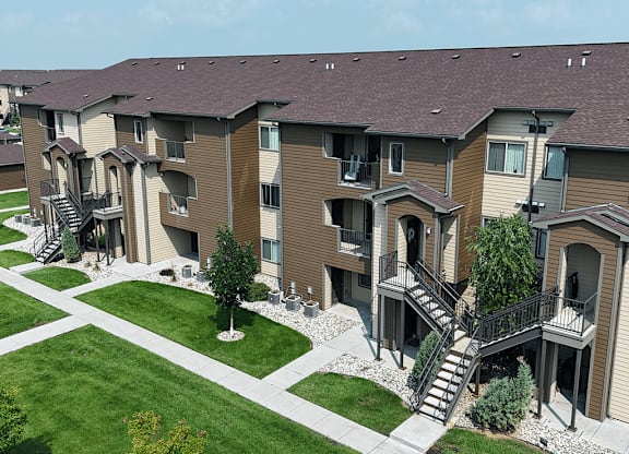 Apartment complex with a green lawn in front.