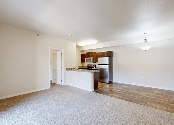 A kitchen with white cabinets and a stainless steel refrigerator.