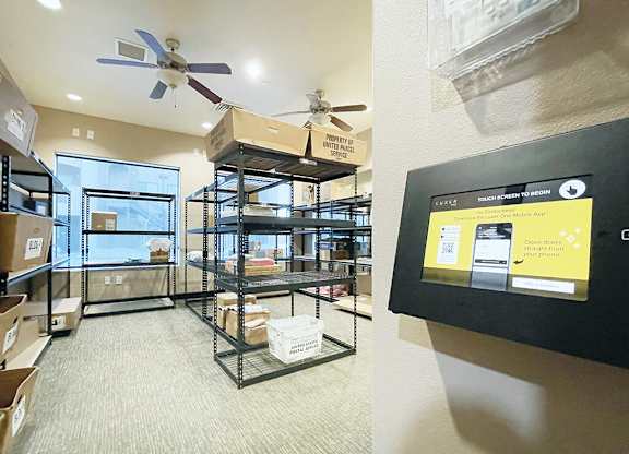 A room with a ceiling fan and a wall-mounted touch screen display.