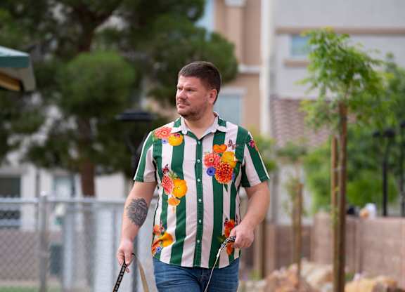 A man walking his dog on a leash. at Habitat @ DTLV, Las Vegas, NV