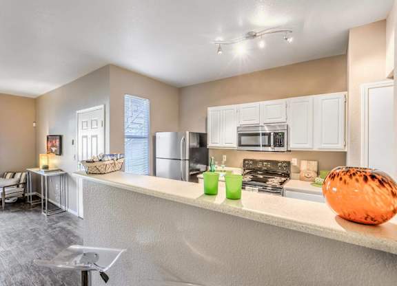 A kitchen with a white counter and a bowl on it.