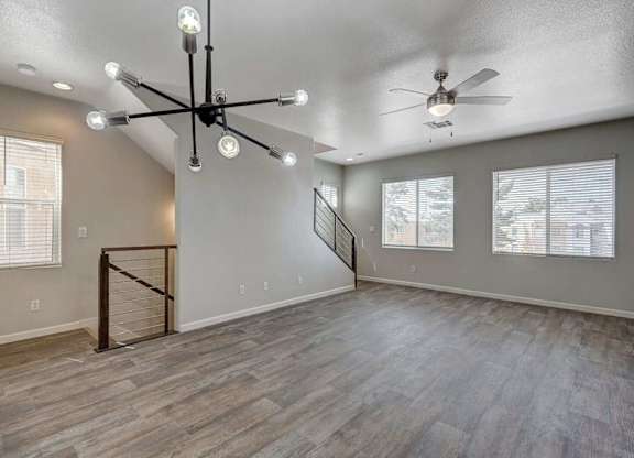 A spacious room with a staircase and a ceiling fan. at Habitat @ DTLV, Las Vegas, NV