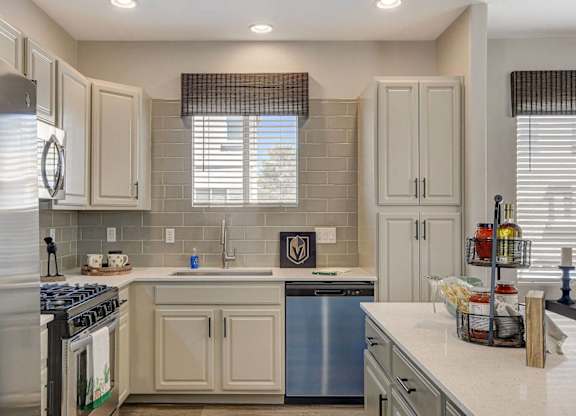 A kitchen with a stove top oven and a dishwasher. at Habitat @ DTLV, Nevada