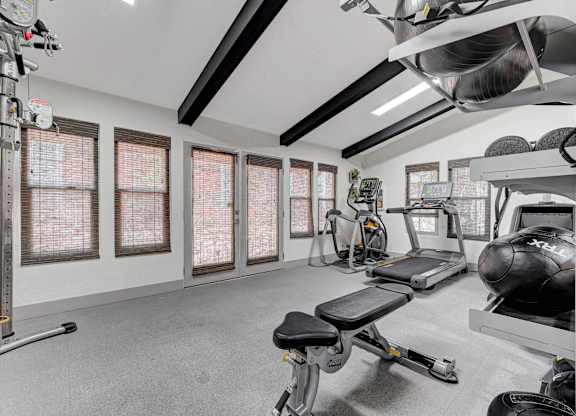 A well-equipped home gym with a variety of exercise machines.