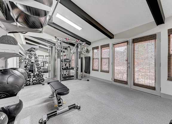 A well-equipped gym with a variety of machines and weights.