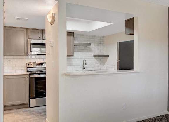 A kitchen with a stove top oven and a microwave.