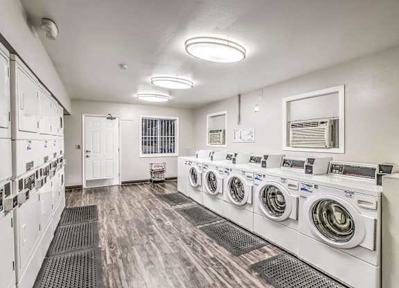 A row of washing machines in a laundromat.