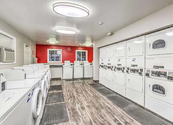 A row of washing machines in a laundromat.