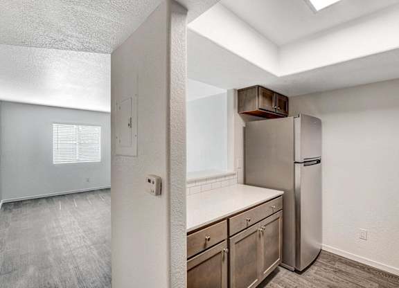 A kitchen with a refrigerator and a countertop. at The 95 Apartments, Nevada