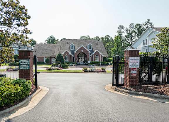 A gated entrance to a residential area with a sign that reads "No Trespassing".