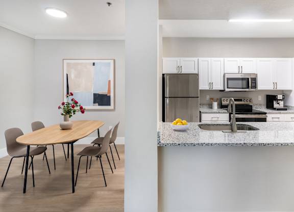 A modern kitchen with a dining table and chairs.